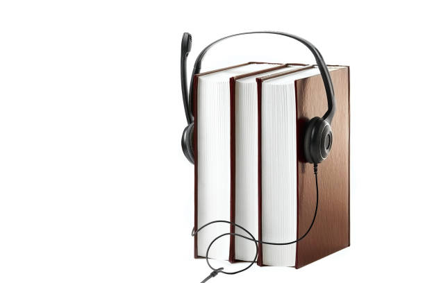 istock Black headphones dressed on standing books on a white background. 1393425692