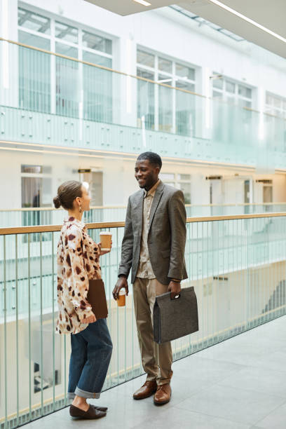 istock Young People Chatting at Office Balcony 1393425780