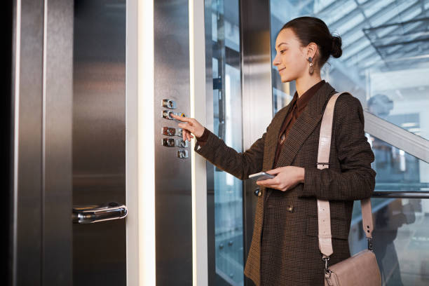 Young Businesswoman in Elevator