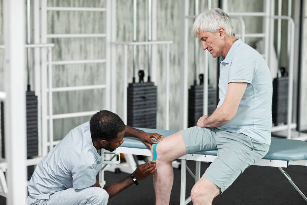istock Taping on Injured Knee 1393428205