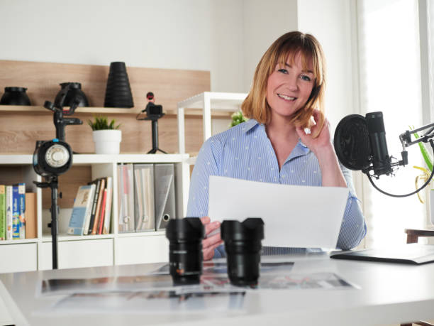 istock Female photographer working at office studio 1393429496