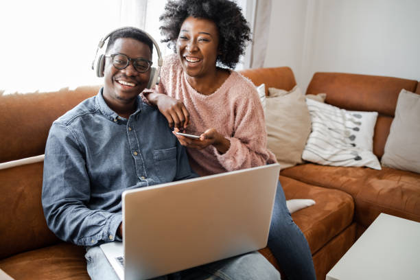 istock Heterosexual couple using laptop at home 1393429820