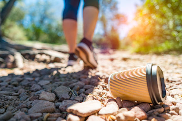 Used coffee cup discarded on the ground by hiker