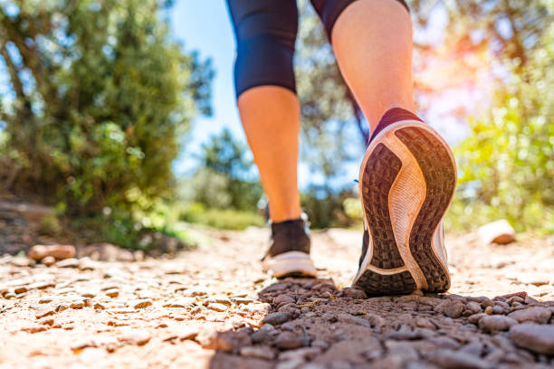 istock Woman walking on mountain footpath 1393429907