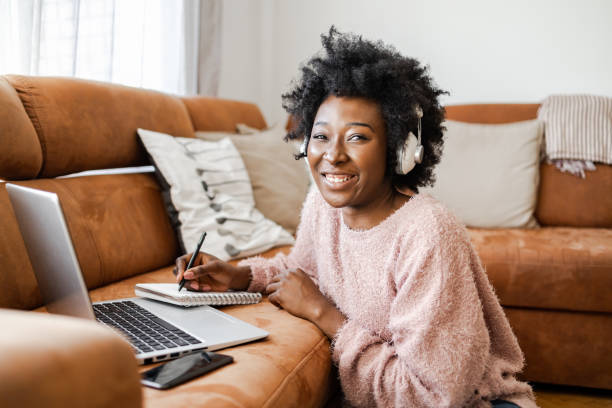 istock Portrait of a young woman looking at camera while using a laptop 1393429914