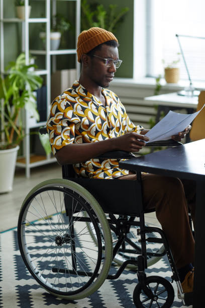 istock African American Man using Wheelchair at Office 1393433002