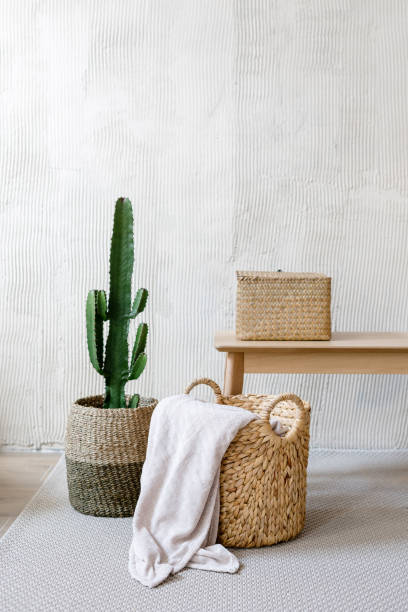 istock Storage box, wicker basket with plaid and cactus near wooden table 1393435336
