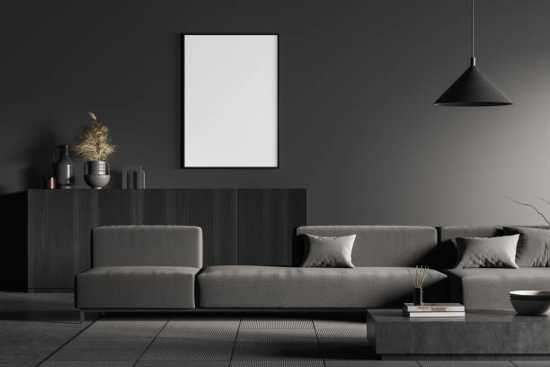 istock Dark living room interior with empty white framed mockup poster on wall, sofa, table, commode, concrete floor. Concept of minimalist design. Creative idea. Mock up. 3d rendering 1393436277