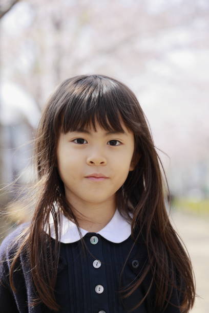 istock Japanese girl and cherry blossoms (7 years old) 1393436331