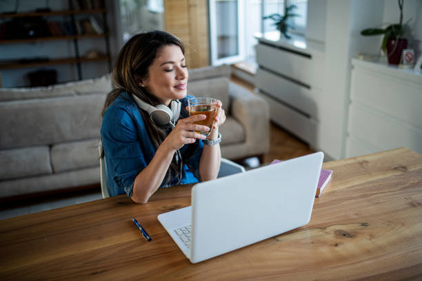 istock A young woman is resting during a break from a video call a drinking tea 1393436364