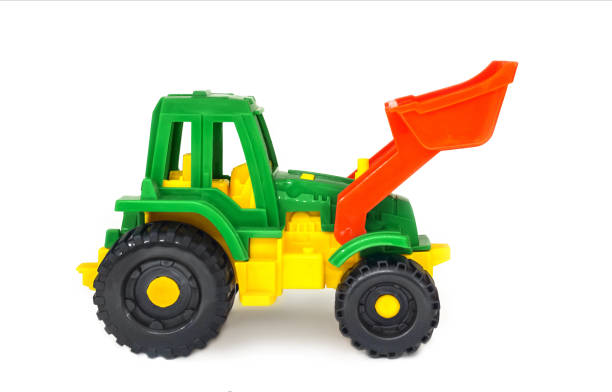 istock colorful plastic toy wheeled tractor loader excavator, isolated 1393445192