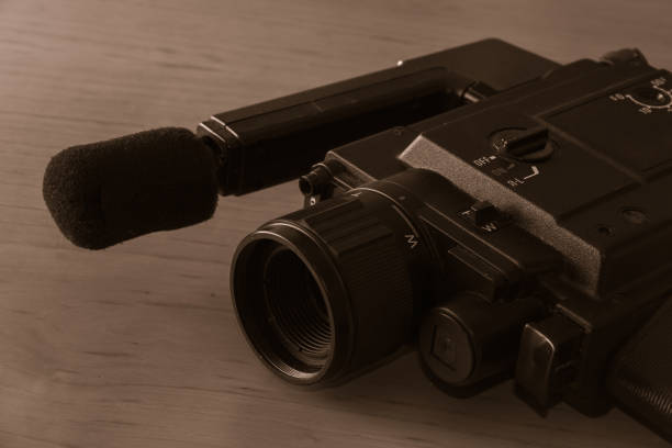 istock Vintage 8mm video camera on wooden background. Copy space. Selective focus. 1393445221
