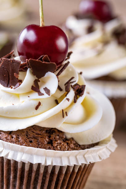 istock cupcake with vanilla cream and cherry close up 1393448464
