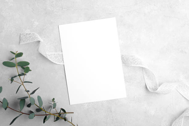 istock Wedding stationery invitation cards mockup 5x7 on neutral grey stone background with eucalyptus leaves 1393448510