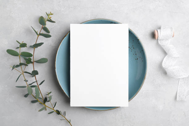 istock Wedding stationery invitation card mockup 5x7 on grey background with eucalyptus, Menu card mockup with table setting 1393448527