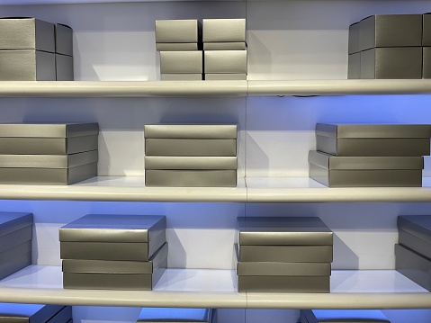 Shelves full of silver retail gift boxes in a department store