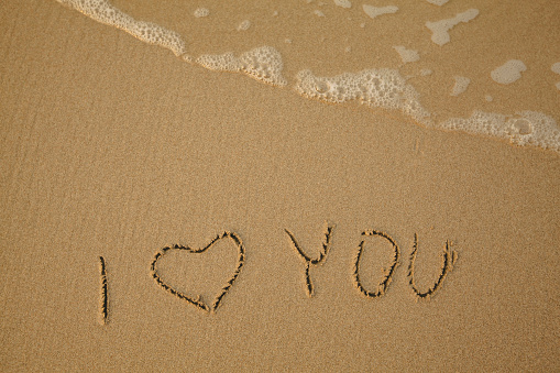 I Love You - handwritten on the soft beach sand.