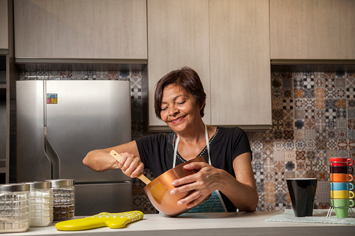 Brazilian woman cooking and smiling. Happy. Positivity. happiness