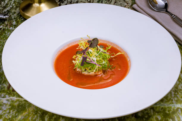istock Gazpacho soup on a white plate on green marble table 1393463644