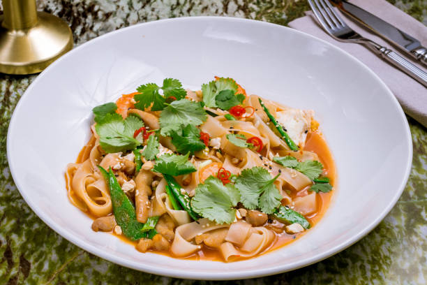 istock Udon noodles with chicken and vegetables on white plate 1393463746