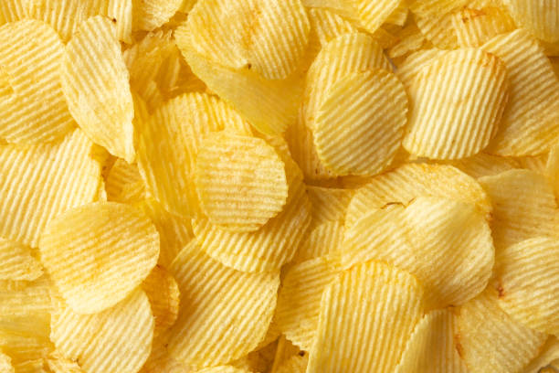 istock crispy golden potato chips snack texture background 1393464905