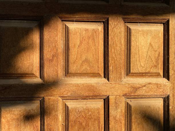 istock Sunlight shining on wooden door 1393473812