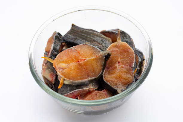istock Catfish cut pieces in glass bowl on white background. 1393482960