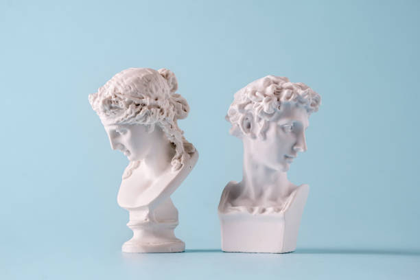 istock Small antique style Roman busts facing away from each other 1393489759