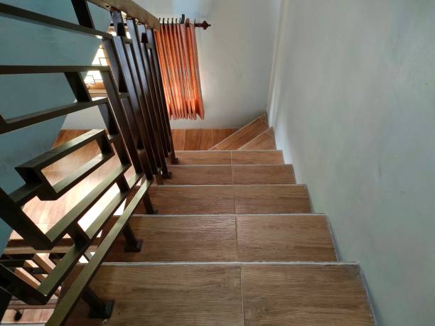 istock wooden patterned staircase and stainless steel railing 1393493637
