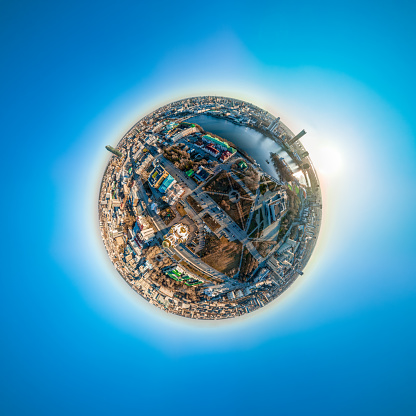 Aerial early spring or autumn city view with crossroads and roads, houses, buildings, parks and bridges. Copter shot. Little planet sphere mode. Spherical panorama of the city, little planet. Yekaterinburg, Russia.