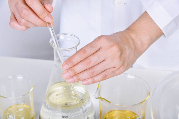 istock Chemical reagent pouring and mixing, Laboratory and science experiments, Formulating the chemical for medical research. 1393503715