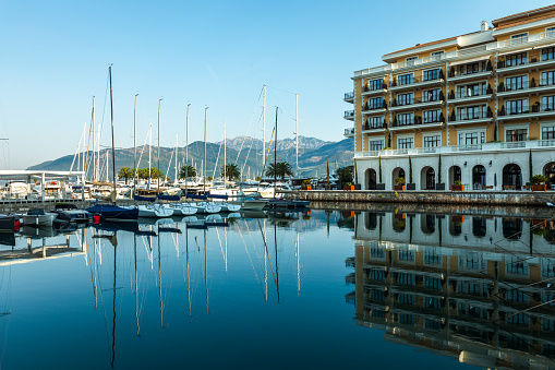 Luxury boats and yachts at the pier of Porto Montenegro at sunset
