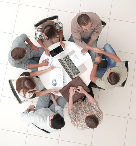 istock top view.an informal meeting with business partners 1393507017