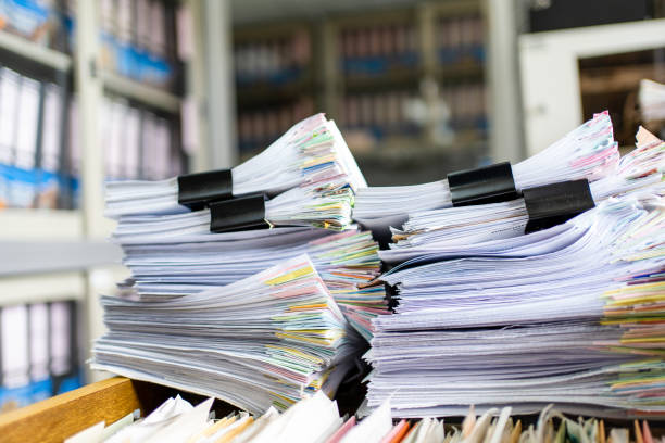 istock documents achieves paper files for searching information on work desk home office 1393508028