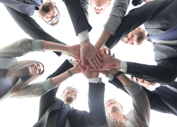 istock bottom view.the business team is making a tower out of hand 1393508111