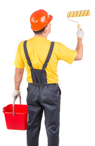 istock A worker with a paint roller and a bucket. 1393508390