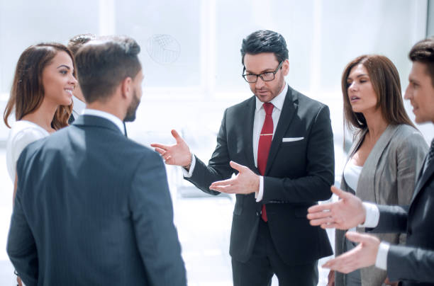 istock close up.a group of employees talking standing in a circle 1393508471