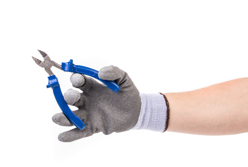 Hand in gloves hold a wire cutters. Isolated on a white background. Close-up.
