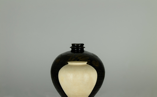 Chinese antique black and white porcelain jars against white background