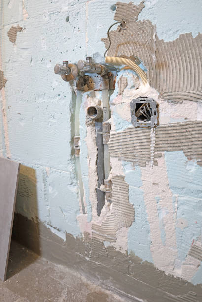 istock Drain pipe and water pipes in a plaster wall 1393511649