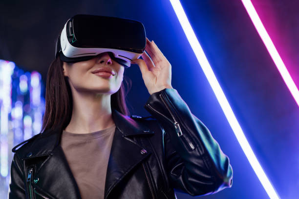 istock Young woman experiencing virtual reality eyeglasses headset 1393513096