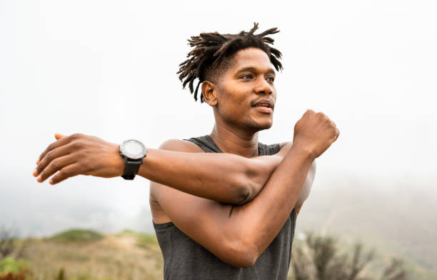 istock Fit young man stretching before a morning trail run 1393513107