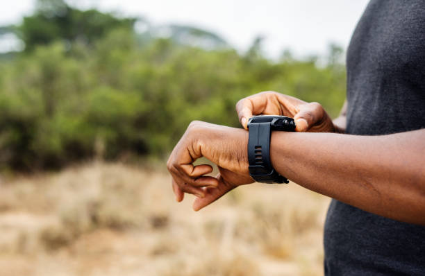 istock Man setting his sports watch during a trail run 1393513183