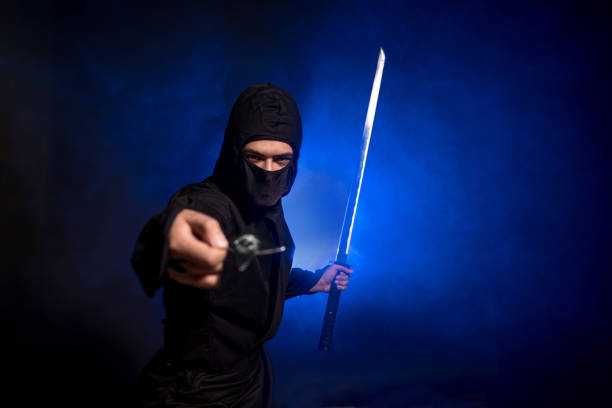 istock Medieval warrior ninja assassin throws shuriken in smoke 1393515996