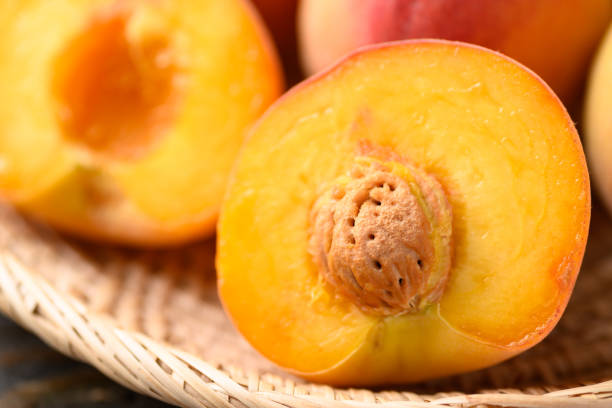 istock Peach fruit in basket on wooden background 1393516031