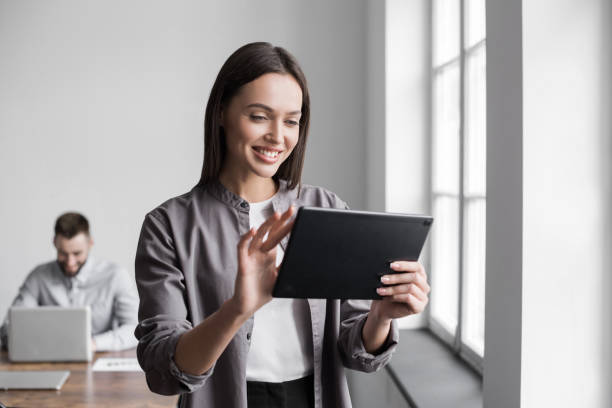 Woman using digital tablet in office stock photo