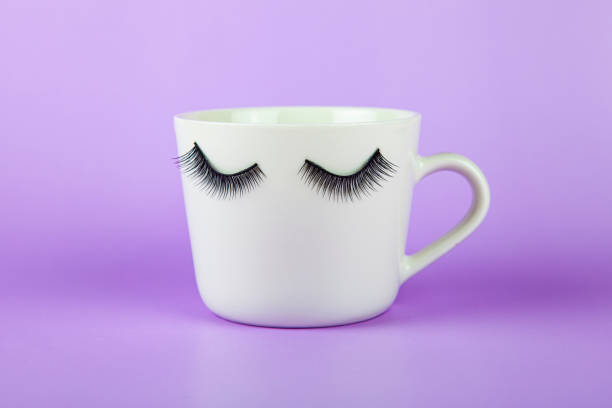 istock Funny white mug with eyes on a lilac background. 1393517497