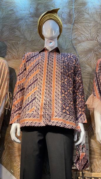istock javanese clothes demonstration. this clothes name batik shot with low level view with mannequin models 1393517563