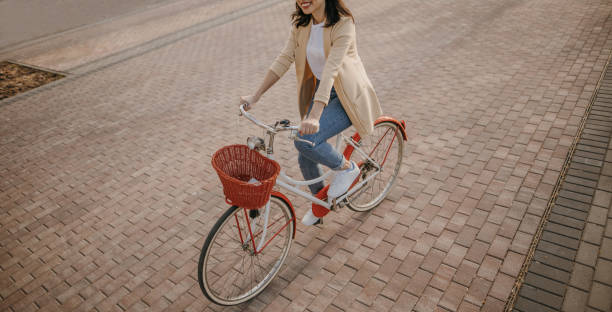 istock Young woman commuting to work on vintage bicycle 1393517758