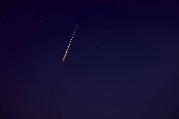 istock Stars, meteor trail on evening sky. 1393519128